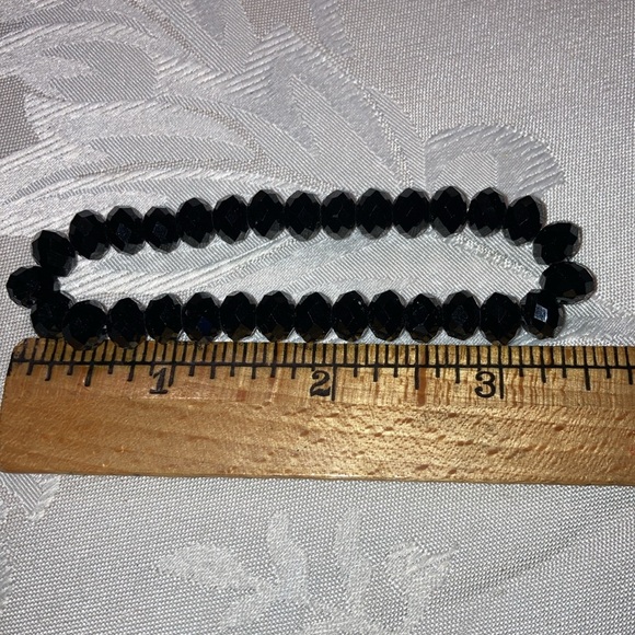 Bracelet w/blk glass faceted beads on elastic so fits most wrists.    $9 - Picture 2 of 3